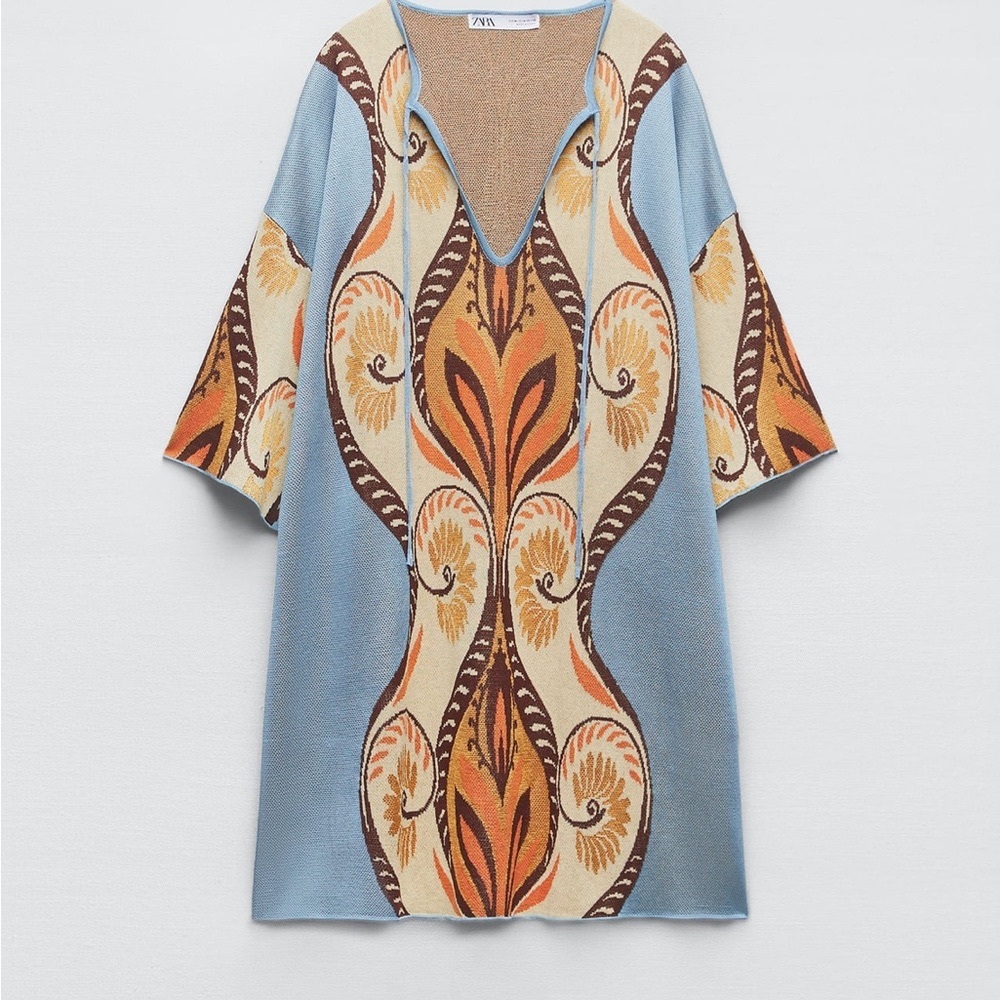 NWT. Mini tunic dress with V-neckline and wide below-the-elbow length sleeves.